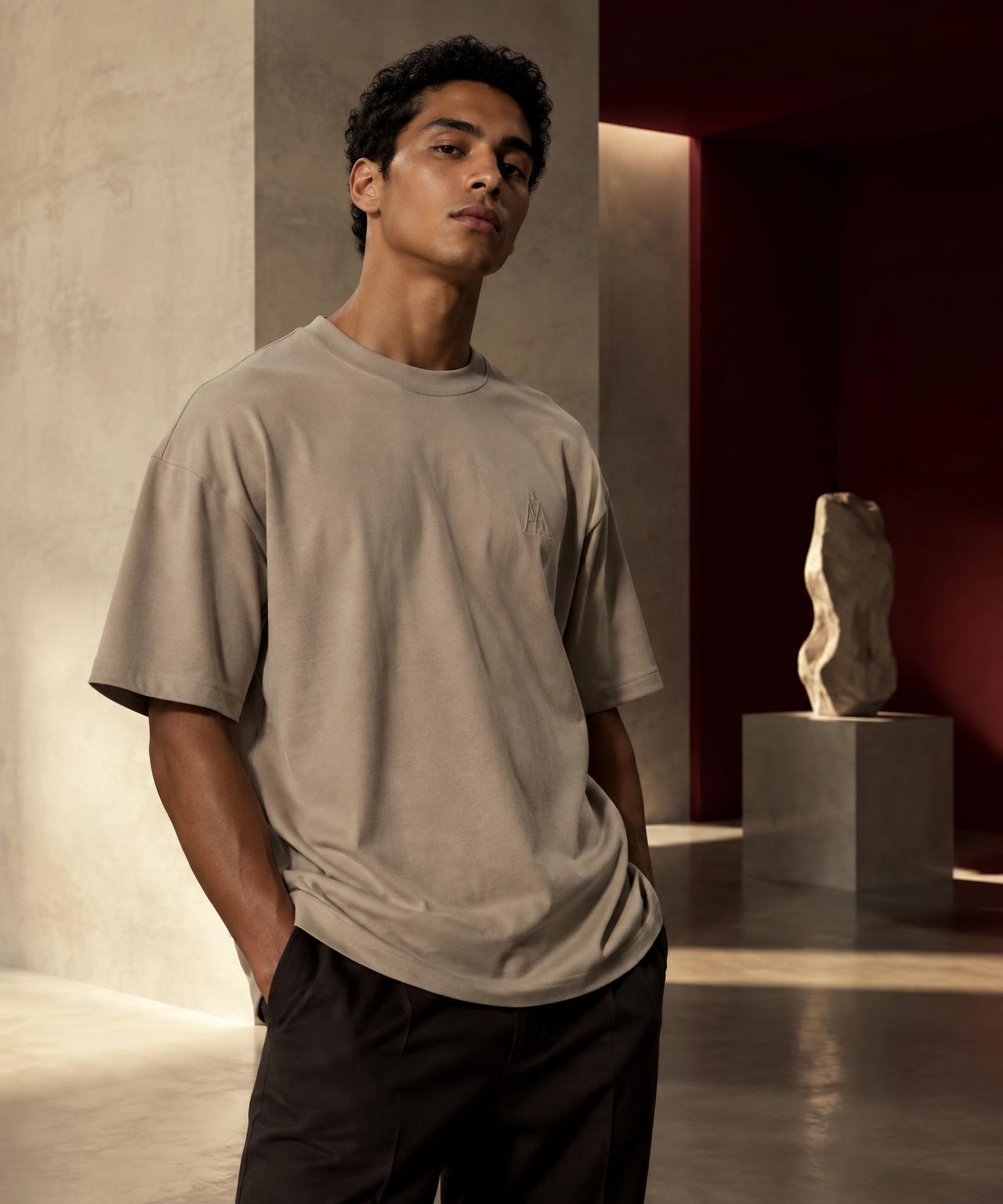 Model wearing a stone A & A oversized T-shirt